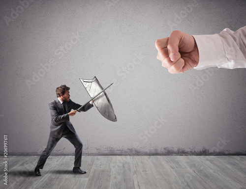 Little business man challenges big problems fighting with shield and sword