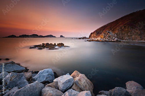 Beautiful landscape photo of amazing bay with sea rocks, sky clouds and soft water © Olga
