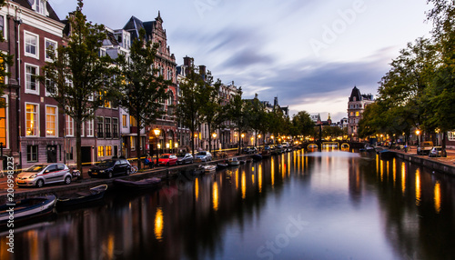 Canal in Amsterdam by night with reflections in the water