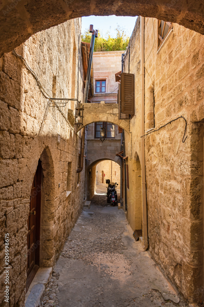 Narrow medieval street of old town in City of Rhodes (Rhodes, Greece)