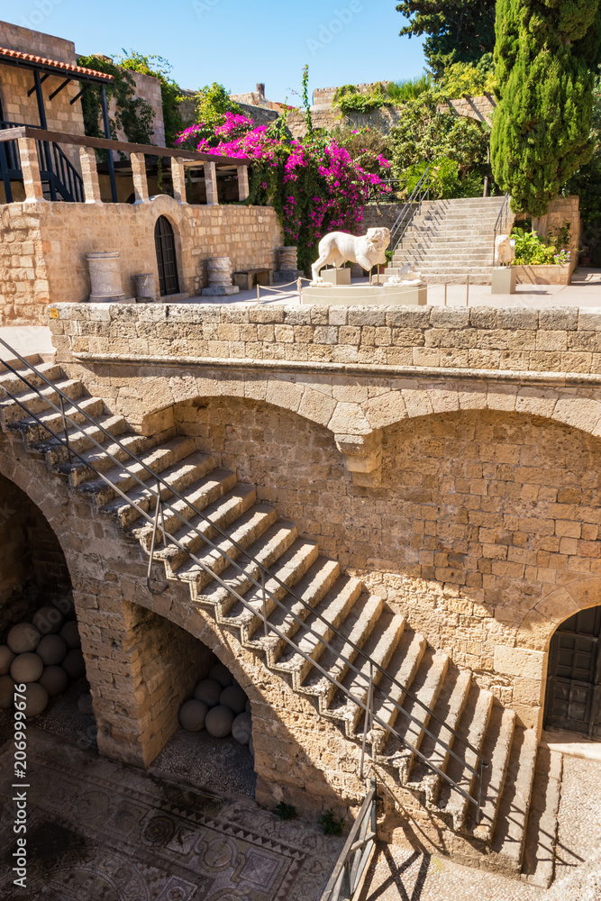 Staircase of medieval house with statues in old town in City of Rhodes (Rhodes, Greece)