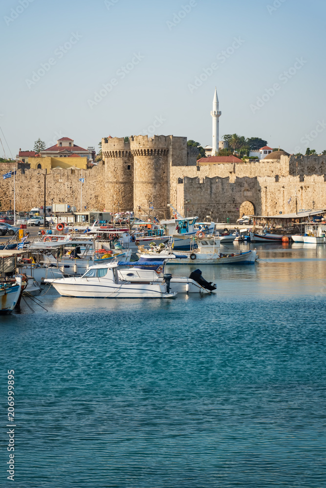Boats in front of entrance gate of medieval city wall in City of Rhodes (Rhodes, Greece)