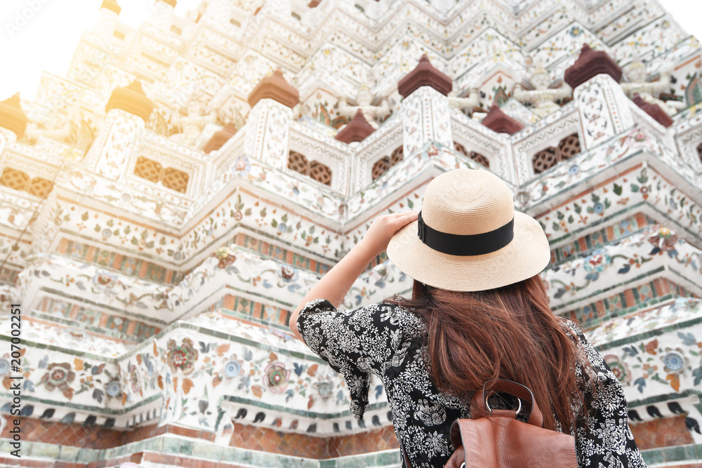 Woman is sightseeing and traveling in Wat Arun in Bangkok, Thailand.
