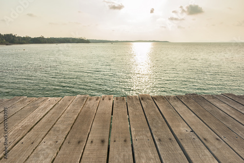 Wooden floor with beautiful ocean and sunset sky.