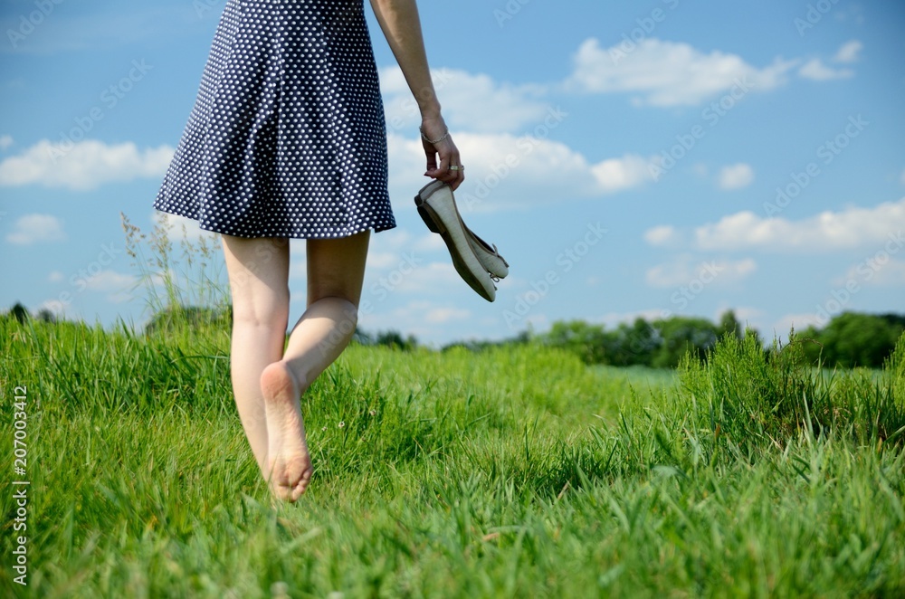 Woman barefoot walk in grass Stock Photo | Adobe Stock