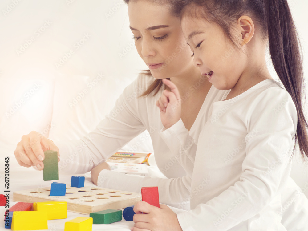 preschool age little Asia children play with colorful plastic toy blocks.Child playing with building blocks learning new skills. preschool age little Asia children play with colorful plastic toy blocks.Child playing with building blocks learning new skills.
