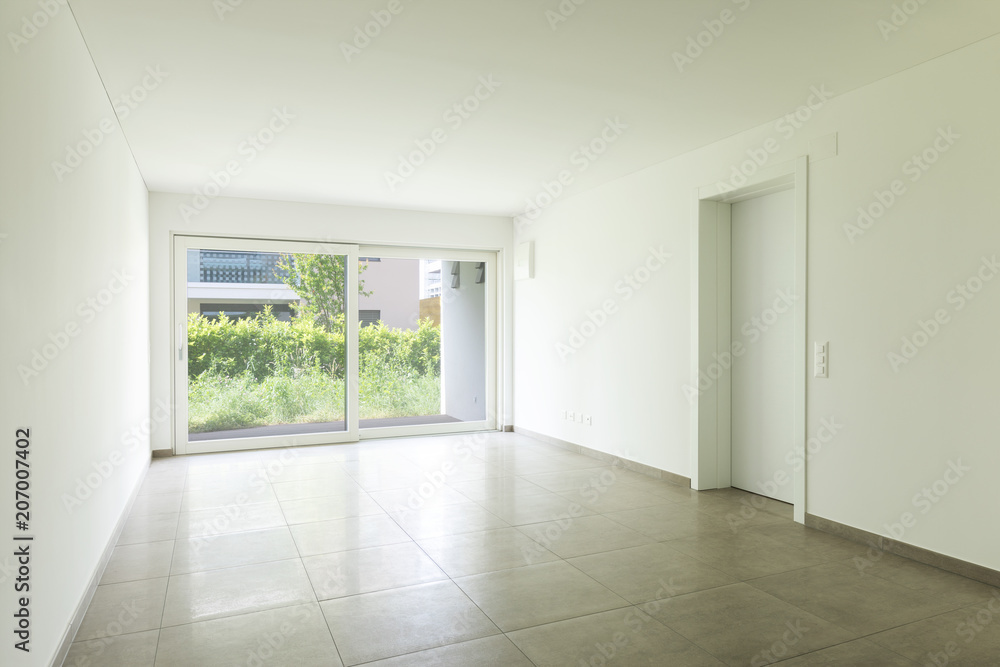 Fototapeta premium Empty room in a modern apartment with white walls, nobody in the scene