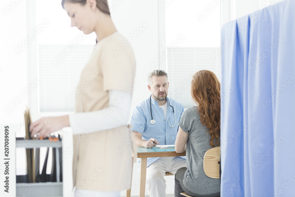 Gynecologist during consultation in office