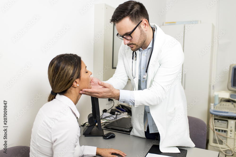 Male doctor examines a female patient