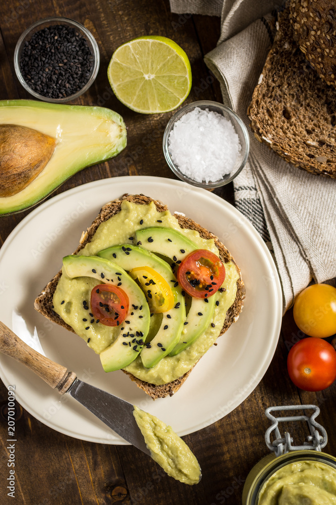 Avocado Spread Guacamole and Slices with Fresh Cherry Tomato and Black Sesame. Healthy Breakfast Concept. Avocado Spread Guacamole and Slices with Fresh Cherry Tomato and Black Sesame. Healthy Breakfast Concept.