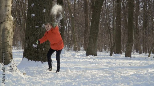 Adorable boy throw snowballs in the camera photo