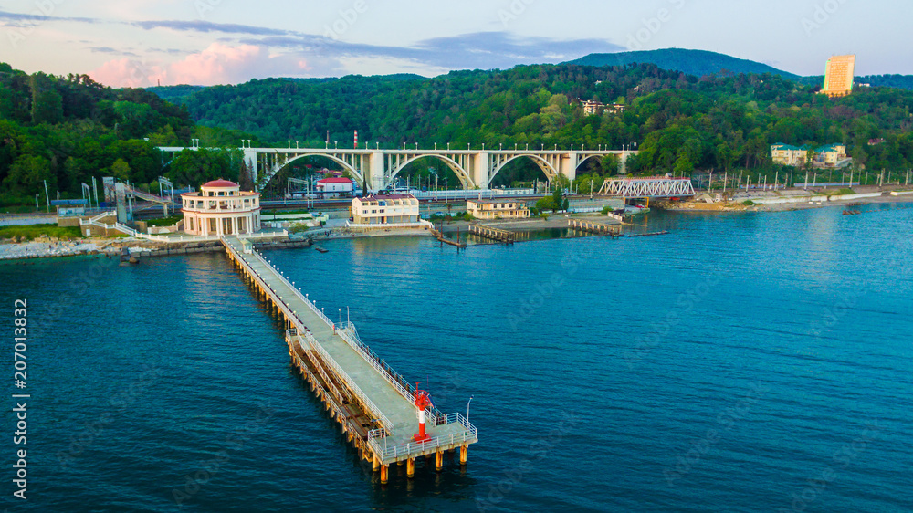 Fototapeta premium Drone view of pier of Matsesta marine station an the background of the Matsesta viaduct in summer day, Sochi, Russia