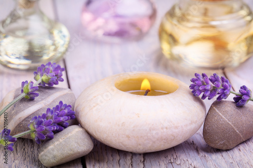 Massage oils, lavender flowers and scented candle