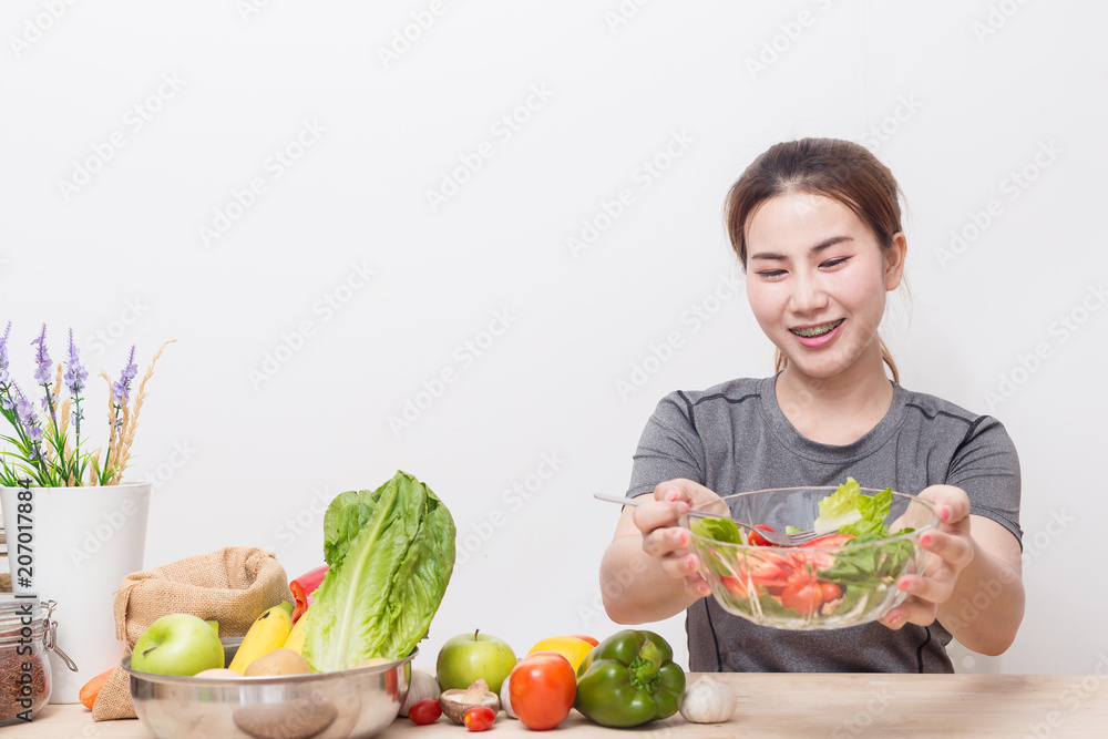 Enjoyed Asian woman eating vegetable salad. Enjoyed Asian woman eating vegetable salad.