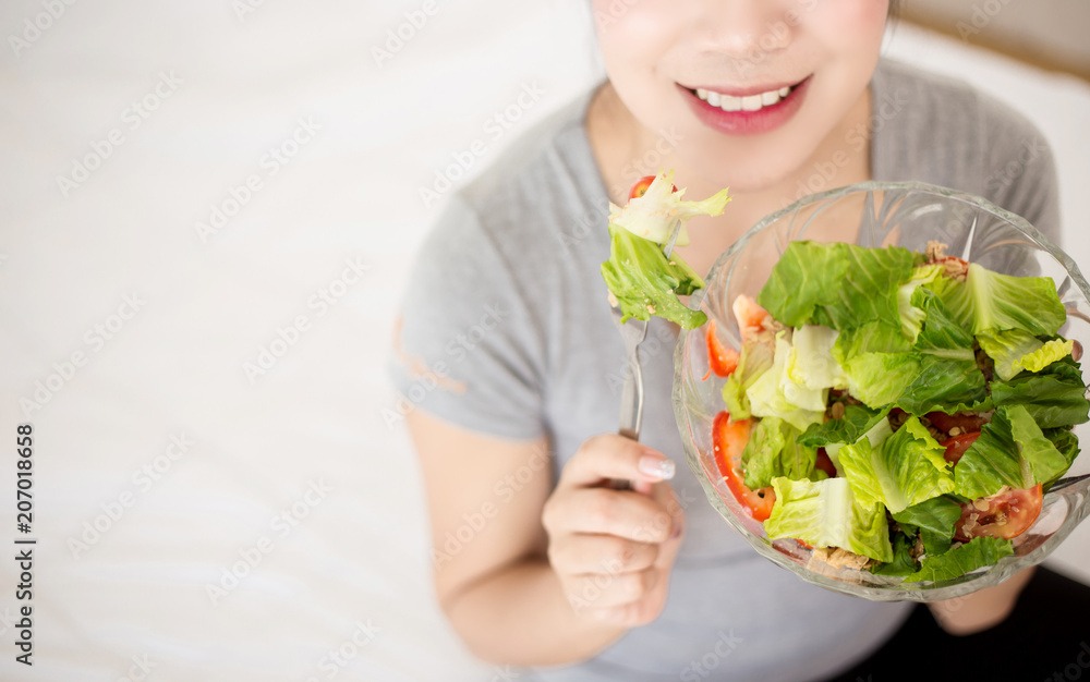 Enjoyed woman eating vegetable salad. Enjoyed woman eating vegetable salad.