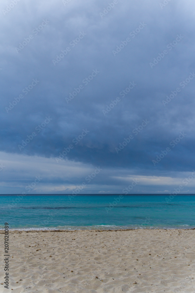 Mallorca, Dark cloudy sky over white sand nature beach landscape of Cala Millor