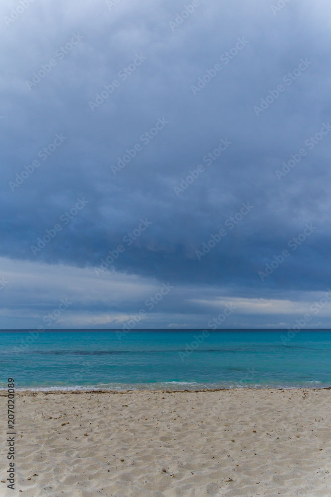 Mallorca, Dark cloudy sky over white sand nature beach landscape of Cala Millor Mallorca, Dark cloudy sky over white sand nature beach landscape of Cala Millor