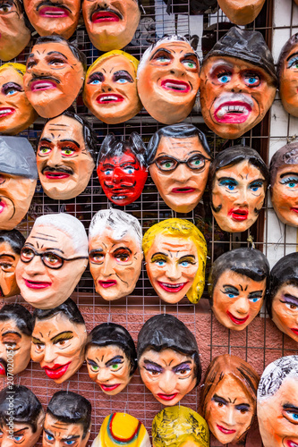 A tienda (market) selling polital and fun masks for an upcoming fiesta (New Year's Eve) in Cuenca, Ecuador photo