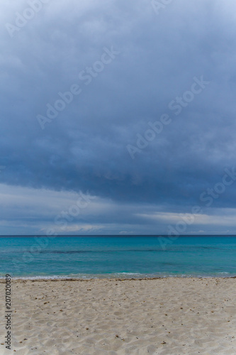 Mallorca, Dark cloudy sky over white sand nature beach landscape of Cala Millor © Simon