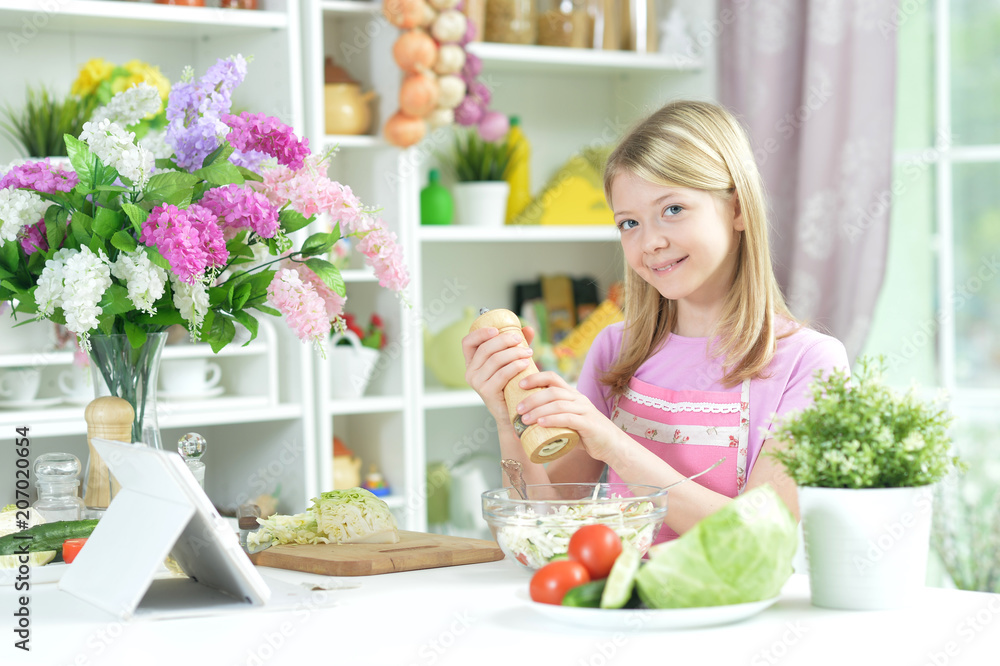Cute little girl preparing fresh salad Cute little girl preparing fresh salad