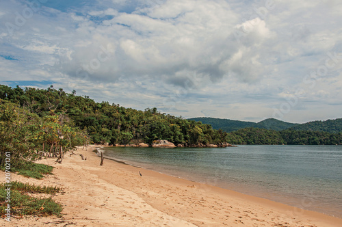 View of beach, sea and forest on cloudy day in Paraty Mirim, a tropical beach near Paraty, an amazing and historic town totally preserved in the coast of the Rio de Janeiro State, southwestern Brazil.