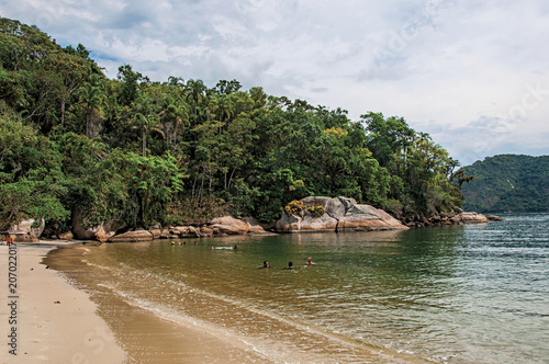 View of beach, sea and forest on cloudy day in Paraty Mirim, a tropical beach near Paraty, an amazing and historic town totally preserved in the coast of the Rio de Janeiro State, southwestern Brazil.