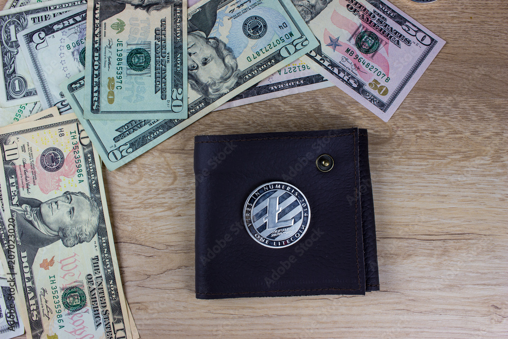 Cryptocurrency Litecoin and wallet. USA dollar banknotes Cryptocurrency Litecoin and wallet. USA dollar banknotes
