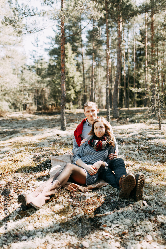 Pre-wedding photo shoot in the forest in nature, in the form of walking and traveling. Beauty of the North and Russia. Loving people and beautiful scenery. They laugh, sit and smile. Beautiful couple Pre-wedding photo shoot in the forest in nature, in the form of walking and traveling. Beauty of the North and Russia. Loving people and beautiful scenery. They laugh, sit and smile. Beautiful couple