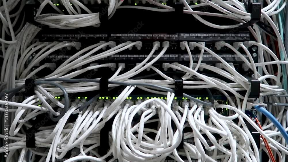 Network cables connected to switch - closeup of data center hardware. Network cables connected to switch - closeup of data center hardware.