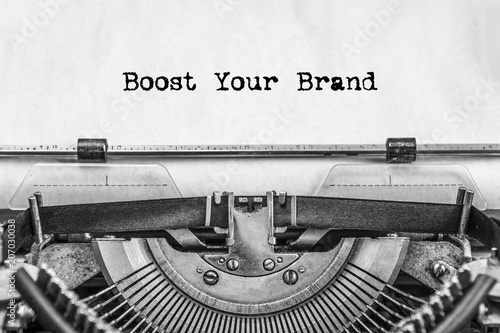 Boost Your Brand text is typed not by a vintage typewriter, old paper, close-up