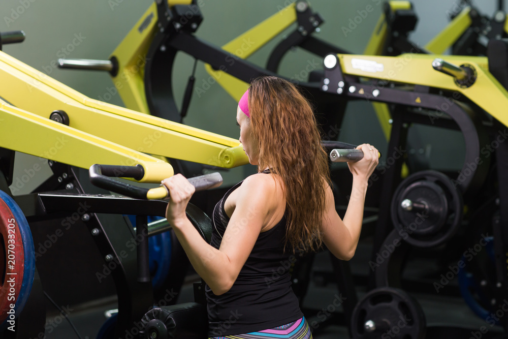 fitness woman execute exercise with exercise machine in gym fitness woman execute exercise with exercise machine in gym