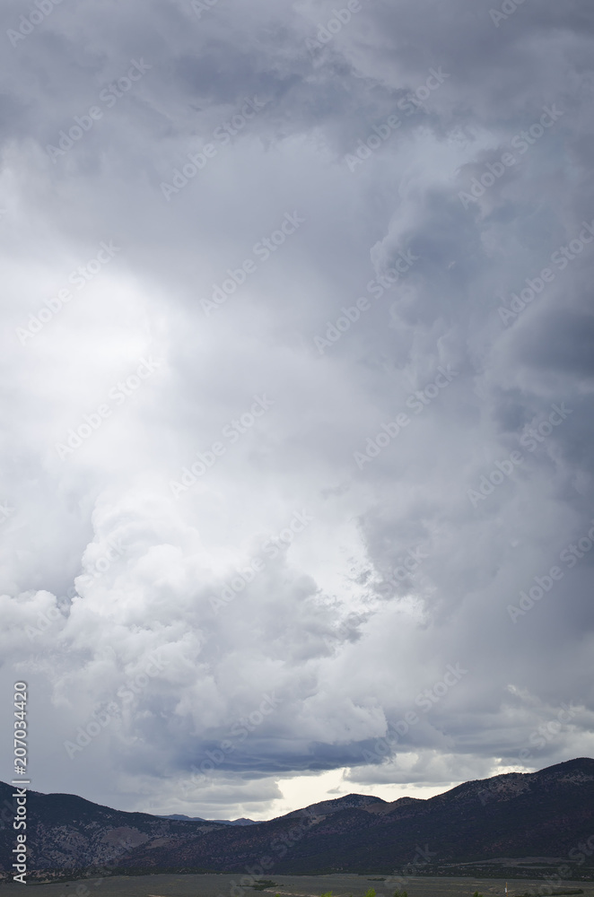The spinning gray overcast storm clouds in the gray sky. The spinning gray overcast storm clouds in the gray sky.