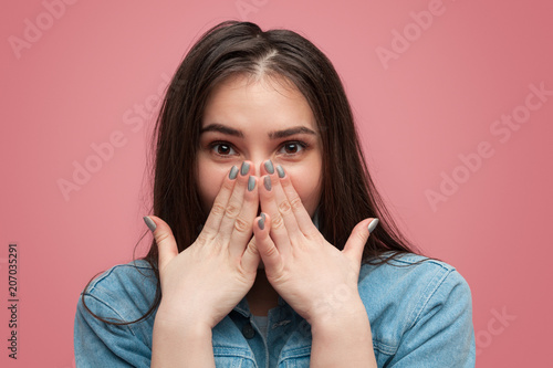 Charming amazed girl covering mouth photo