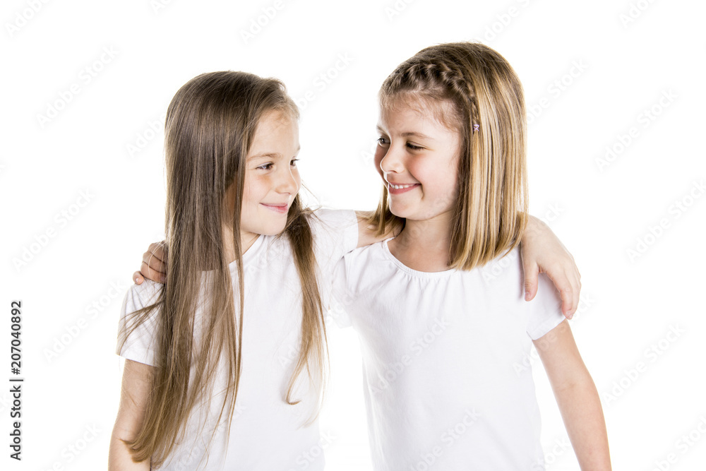 Portrait of two cute friends 7 years old girl Isolated over white background Portrait of two cute friends 7 years old girl Isolated over white background