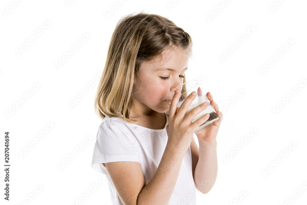 Portrait of a cute 7 years old girl Isolated over white background with milk glass Portrait of a cute 7 years old girl Isolated over white background with milk glass