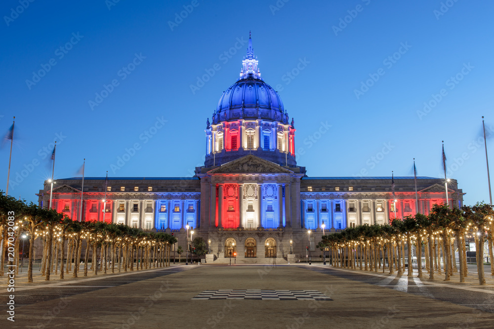 San Francisco City Hall illuminated in Memorial Day Colors. The red, white and blue colors resemble those of the American Flag. Civic Center Plaza, San Francisco, California, USA.