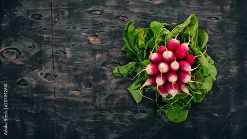 Fresh red radish. On a wooden background. Top view. Copy space.
