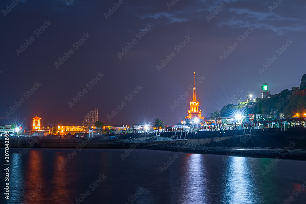 Sochi, Russia - May 23, 2018: Quay of the city of Sochi, at night, overlooking the sea port and lighthouse