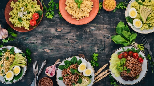 A set of food from buckwheat, bulgur and pasta. On a wooden background. Top view. Copy space.
