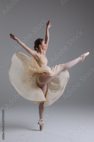 Fototapeta Naklejka Na Ścianę i Meble -  Dancing is creating a sculpture! Beautiful graceful delicate young woman dancing and showing the beauty of a such classical art as ballet.