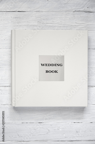 Fototapeta Naklejka Na Ścianę i Meble -  light wedding book on a white wooden background