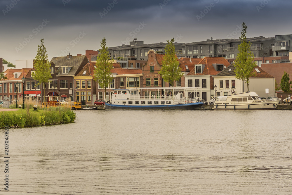 moored boats and houses in alkmaar. netherlands holland