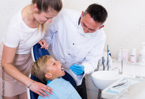 Mother with kid are visiting dentist