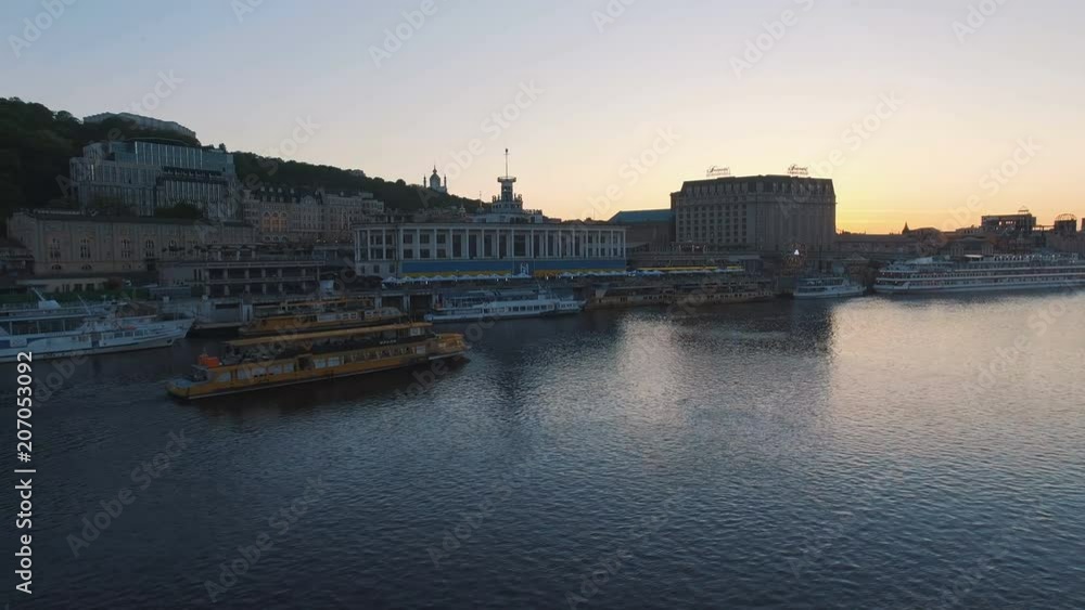 Excursion passenger ship sails to the port of the old European city at sunset Excursion passenger ship sails to the port of the old European city at sunset