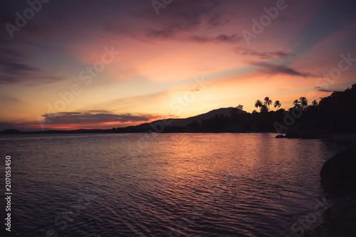 Tropical landscape beach vintage orange sunset sky palm trees coastline 