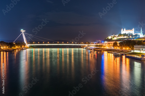 Bratislava, Slovakia May 23, 2018: Night view on new bridge in Bratislava with castle on right side and lights reflection on Dunaj river.