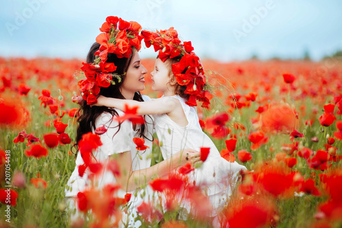 mother and daughter playing in flower field
