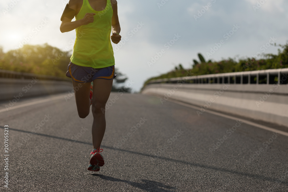 Young fitness woman running on city road Young fitness woman running on city road