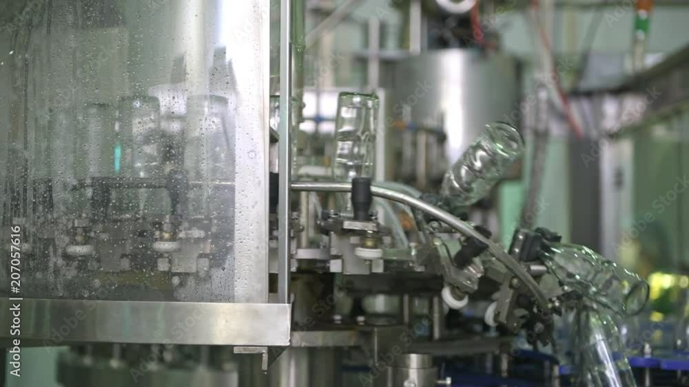Bottle filling machine. High speed automatic liquid bottle filling machine. Manufacturing and production of drinks. Excellence manufacturing concept. Bottle filling machine. High speed automatic liquid bottle filling machine. Manufacturing and production of drinks. Excellence manufacturing concept.