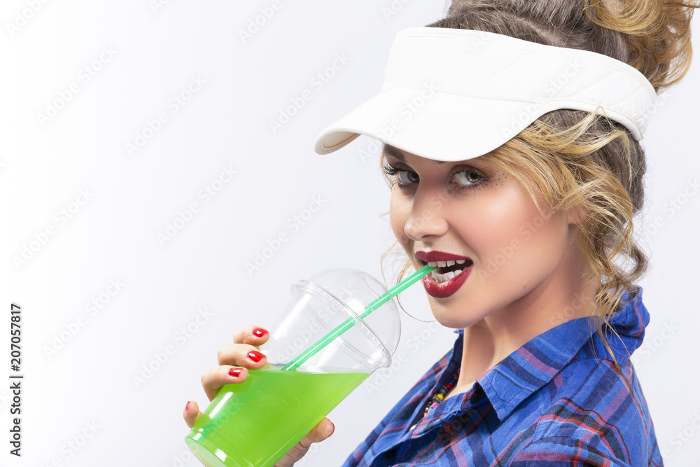 Beauty Ideas and Concepts. Sexy Caucasian Blond Woman in Checked Shirt Over White Background. Drinking Green Juice Through Straw. Beauty Ideas and Concepts. Sexy Caucasian Blond Woman in Checked Shirt Over White Background. Drinking Green Juice Through Straw.